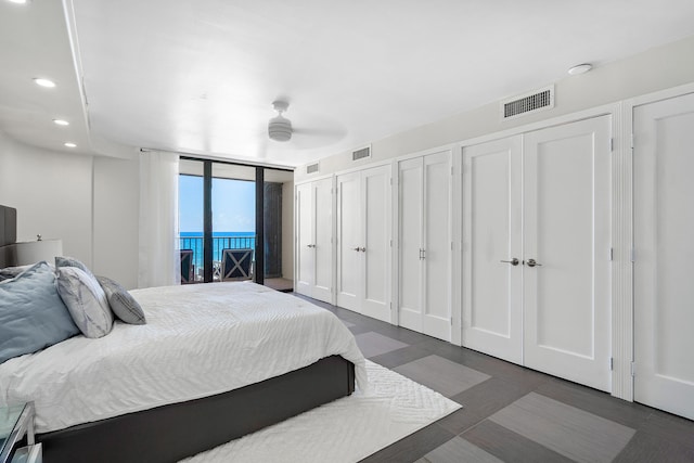 bedroom featuring access to outside, two closets, and ceiling fan