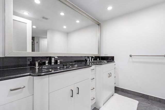 bathroom featuring tile patterned flooring and vanity