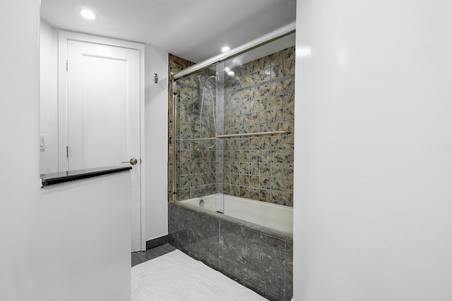 bathroom with shower / bath combination with glass door