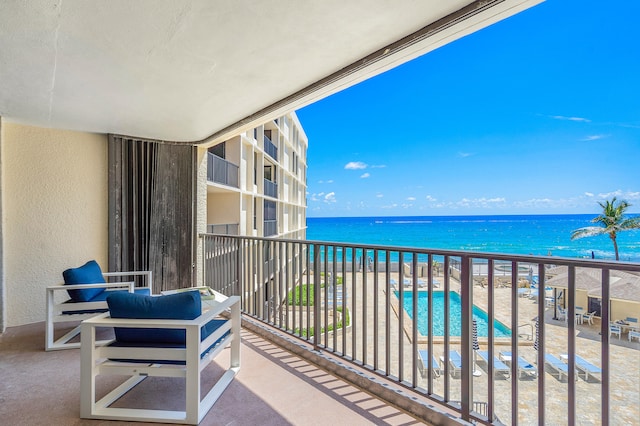 balcony with a beach view and a water view