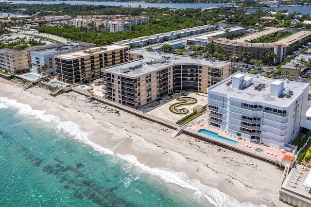 birds eye view of property featuring a view of the beach and a water view