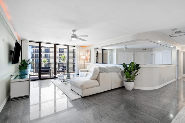 living room featuring floor to ceiling windows and ceiling fan