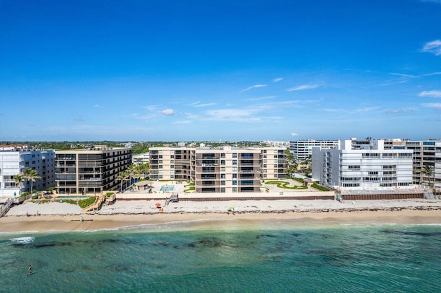 bird's eye view featuring a water view and a beach view