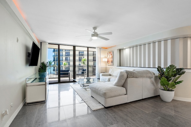 living room with ceiling fan and expansive windows