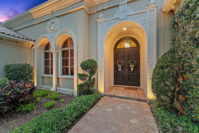 view of exterior entry at dusk