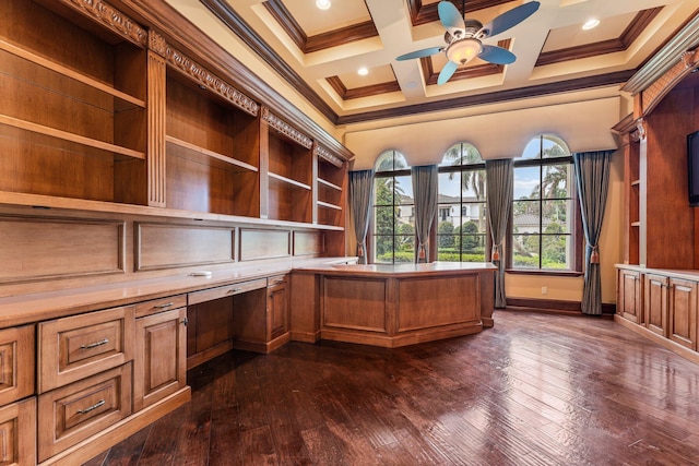 unfurnished office with built in desk, coffered ceiling, crown molding, dark hardwood / wood-style flooring, and ceiling fan