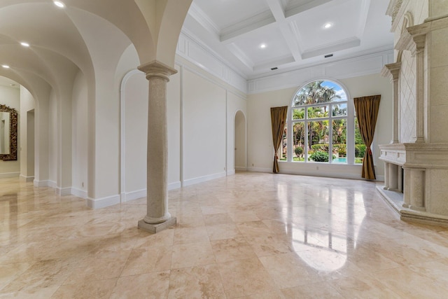 interior space featuring coffered ceiling, beamed ceiling, a high ceiling, ornamental molding, and ornate columns