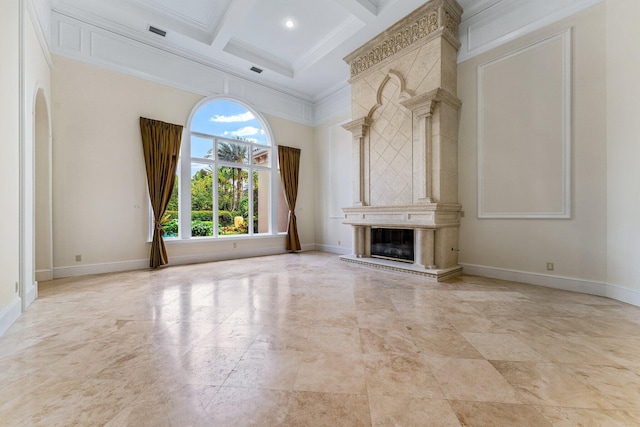 unfurnished living room with crown molding, a premium fireplace, a towering ceiling, and coffered ceiling