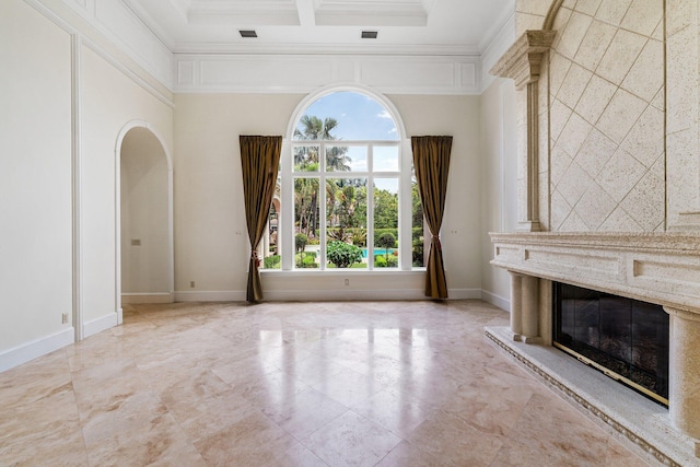 unfurnished living room with a premium fireplace and ornamental molding