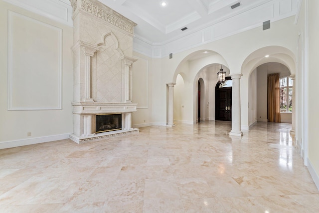 unfurnished living room featuring a high end fireplace, coffered ceiling, decorative columns, a high ceiling, and ornamental molding