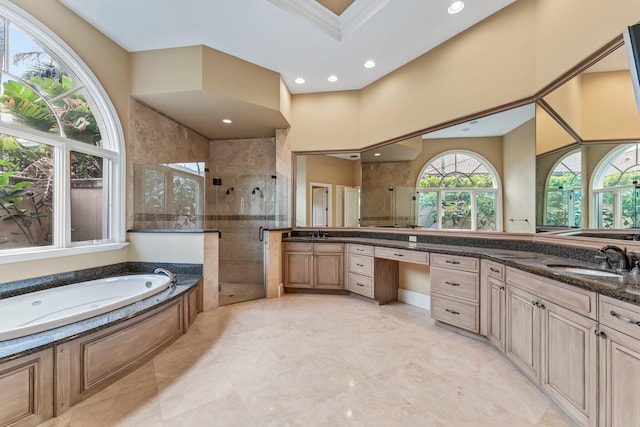 bathroom with a high ceiling, separate shower and tub, ornamental molding, and vanity