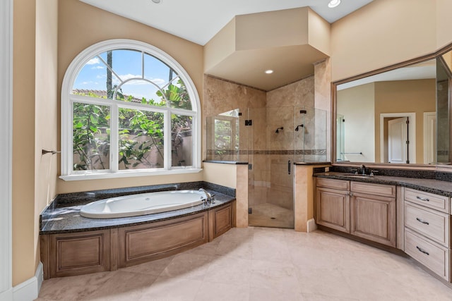 bathroom featuring vanity and shower with separate bathtub