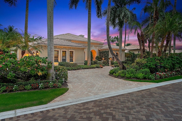 mediterranean / spanish house featuring a lawn