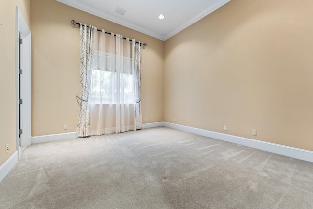 carpeted spare room featuring crown molding