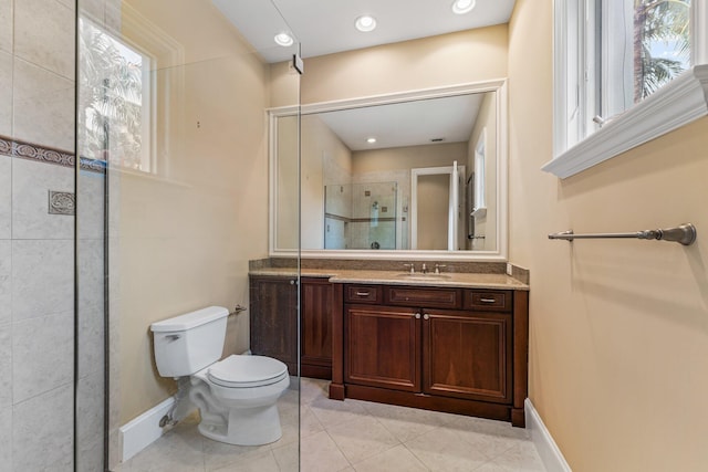 bathroom featuring tile patterned floors, a shower with shower door, toilet, and vanity