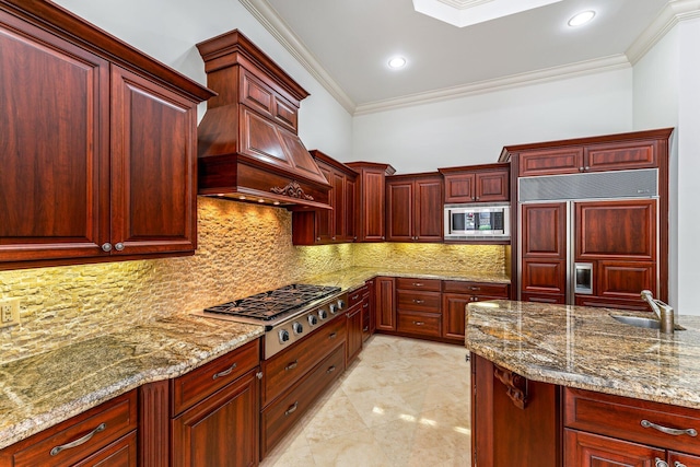 kitchen with custom exhaust hood, crown molding, built in appliances, tasteful backsplash, and sink