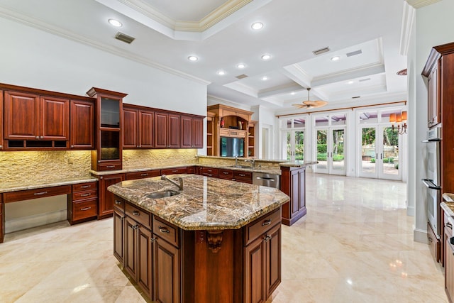 kitchen featuring stone counters, ornamental molding, decorative backsplash, french doors, and a center island with sink