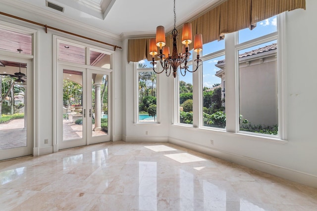 unfurnished dining area featuring crown molding and an inviting chandelier