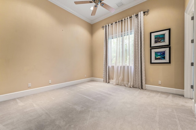 carpeted empty room featuring ceiling fan and ornamental molding