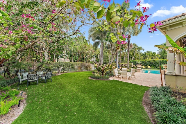 view of yard featuring a fenced in pool and a patio area