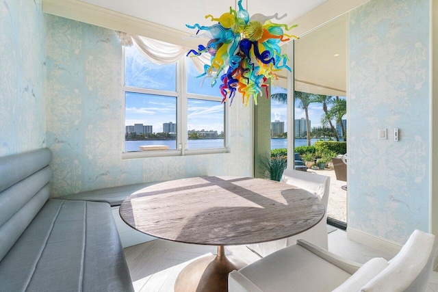 dining space with hardwood / wood-style floors and ornamental molding