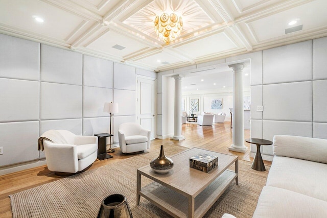 living room featuring a chandelier, beamed ceiling, hardwood / wood-style flooring, and coffered ceiling