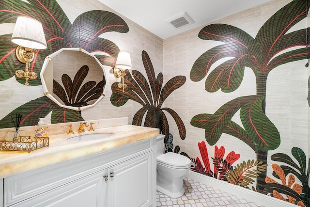 bathroom featuring vanity and toilet