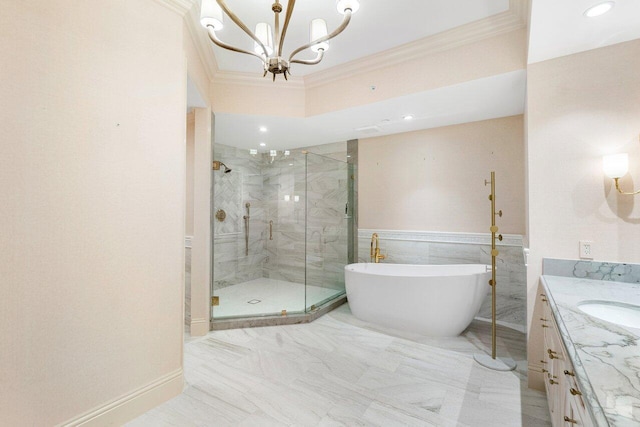 bathroom featuring vanity, ornamental molding, shower with separate bathtub, and a chandelier