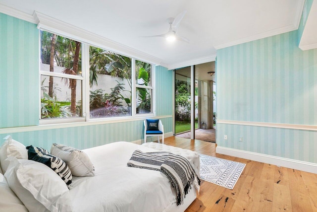 bedroom with ceiling fan, wood-type flooring, and ornamental molding