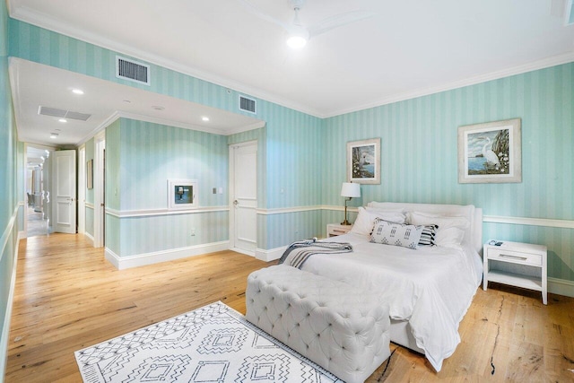 bedroom featuring ceiling fan, wood-type flooring, and ornamental molding