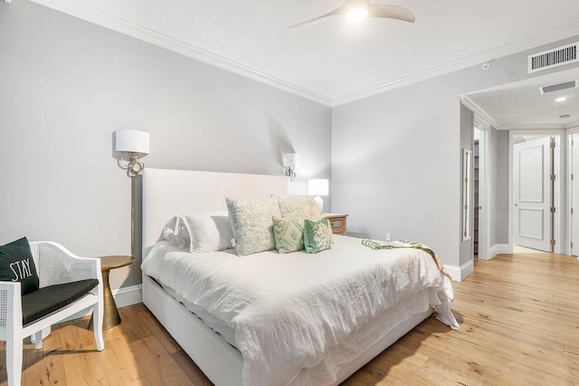 bedroom featuring ceiling fan, crown molding, and hardwood / wood-style flooring