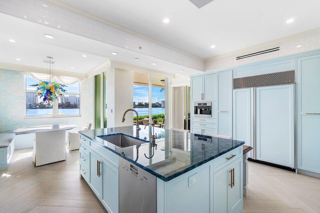 kitchen with stainless steel dishwasher, plenty of natural light, paneled refrigerator, and sink