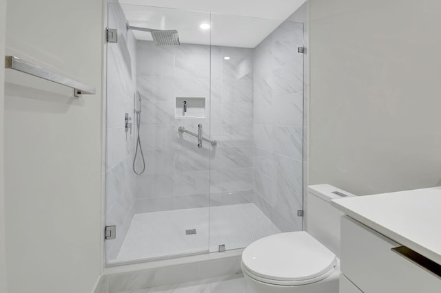 bathroom with vanity, an enclosed shower, and toilet