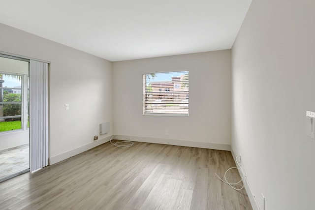 unfurnished room featuring plenty of natural light and light hardwood / wood-style floors