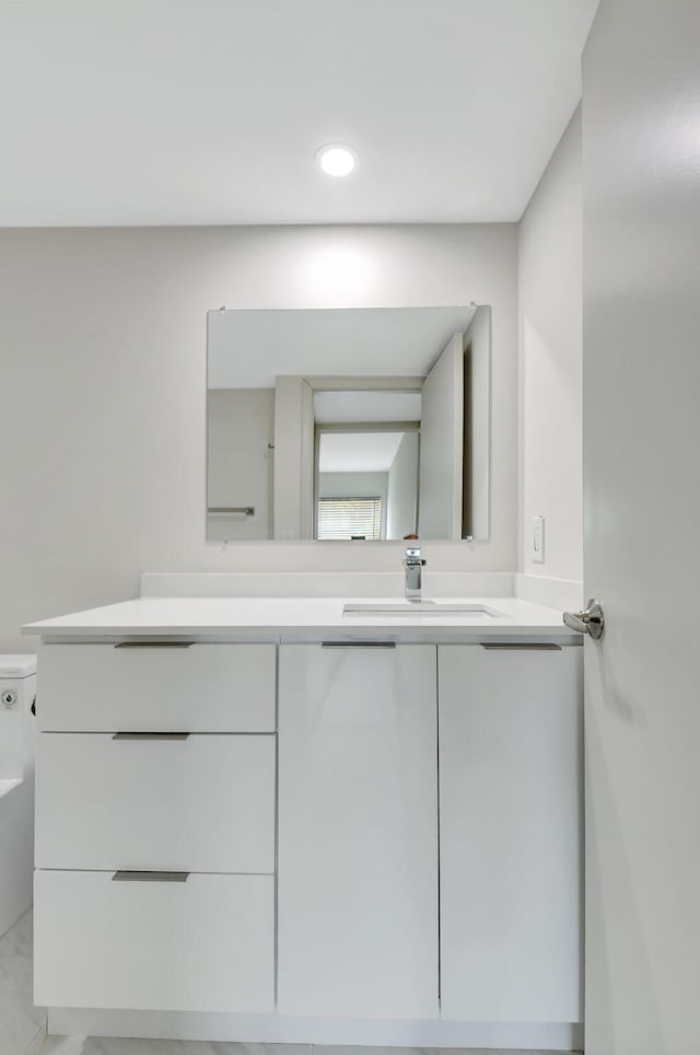 bathroom featuring vanity and toilet