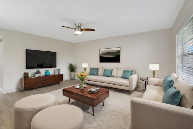 living room featuring light wood-type flooring and ceiling fan