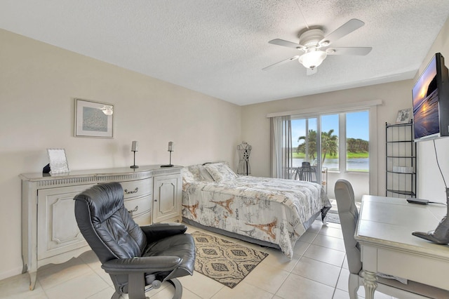 tiled bedroom with a textured ceiling and ceiling fan