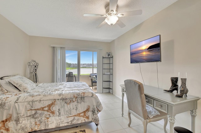 tiled bedroom with ceiling fan and a textured ceiling