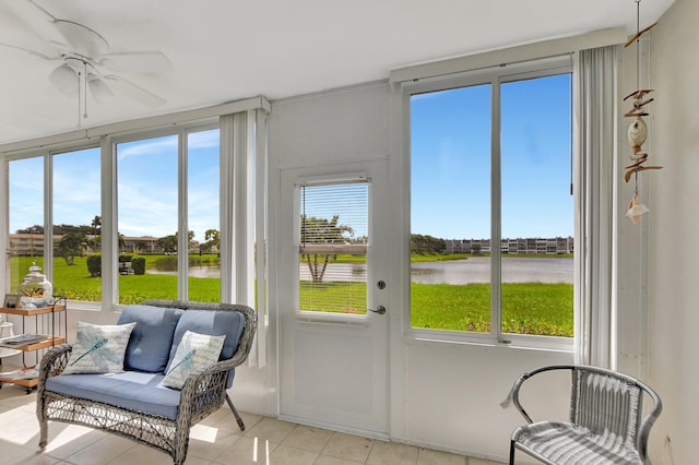 sunroom / solarium featuring a water view, ceiling fan, and a wealth of natural light