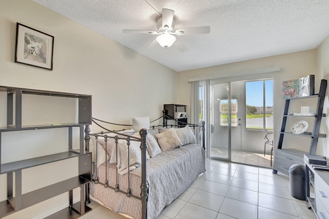 tiled bedroom featuring a textured ceiling, access to exterior, and ceiling fan