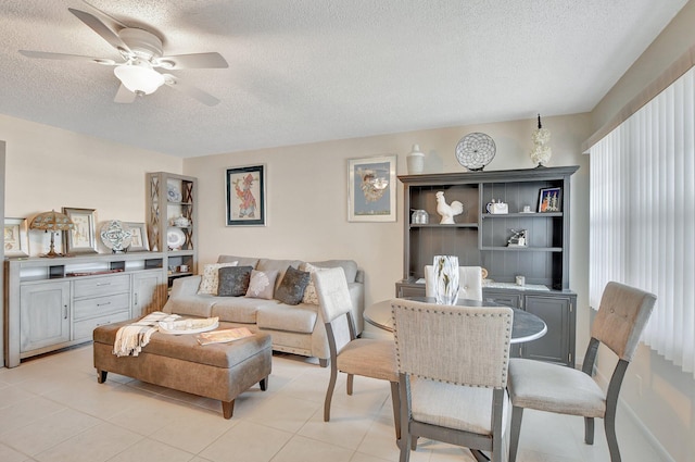 living room featuring a textured ceiling and ceiling fan