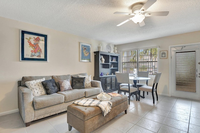 tiled living room with a textured ceiling and ceiling fan