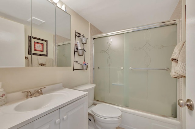 full bathroom with shower / bath combination with glass door, vanity, and toilet