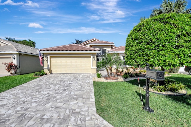 view of front of house featuring a garage and a front lawn