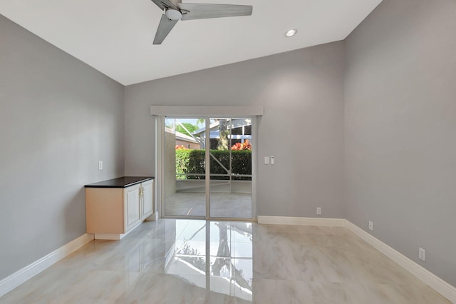 empty room with lofted ceiling and ceiling fan