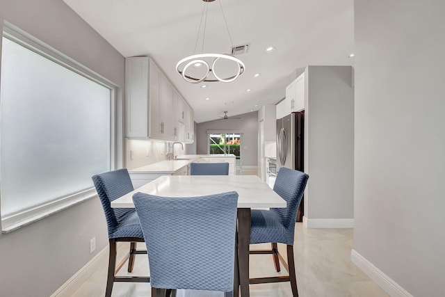 dining room with vaulted ceiling and sink