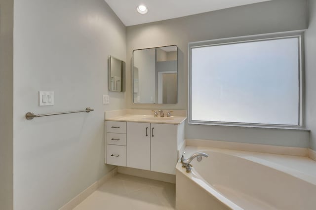 bathroom with a bath, tile patterned floors, and vanity