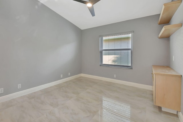 spare room featuring vaulted ceiling and ceiling fan