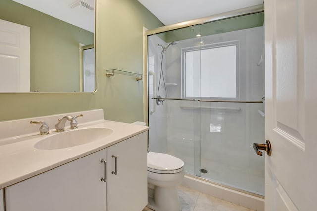 bathroom featuring vanity, toilet, tile patterned floors, and walk in shower