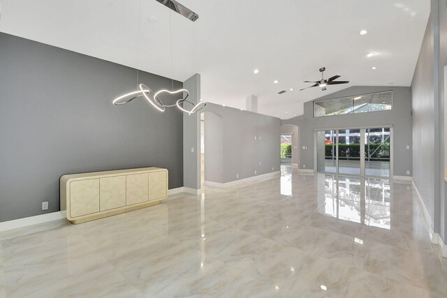 unfurnished living room with high vaulted ceiling and ceiling fan